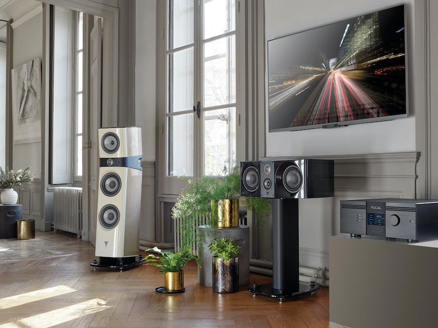 Entertainment setup with television and Focal’s Sopra speakers and receiver; green plants decorate the area.