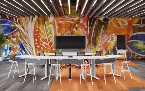 A colorful conference room with white tables and a video conferencing system.