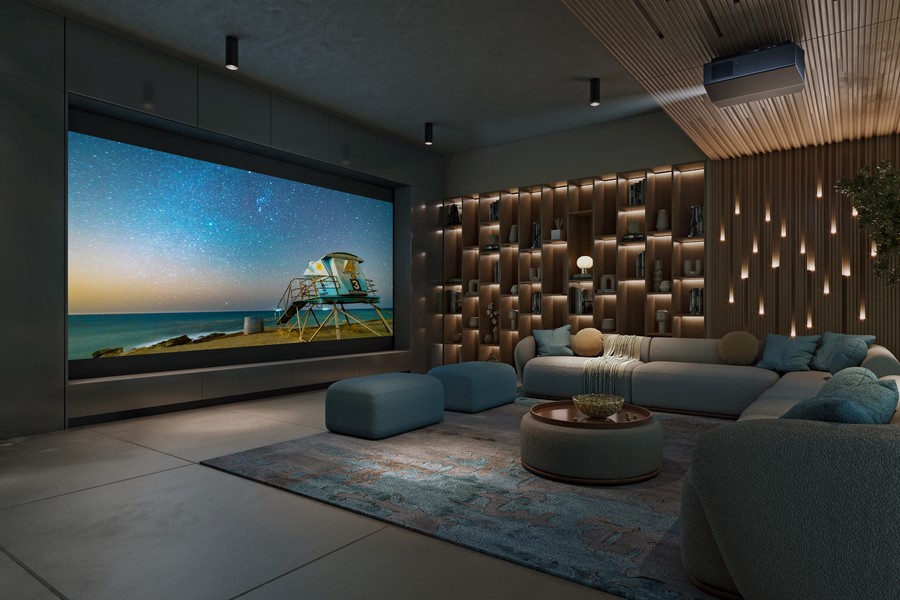 A casual home theater with beautiful lighting, a sectional, large movie screen, and Sony projector.