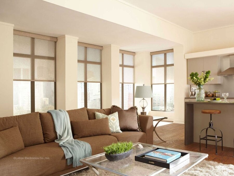 A living space with several windows featuring motorized window treatments.