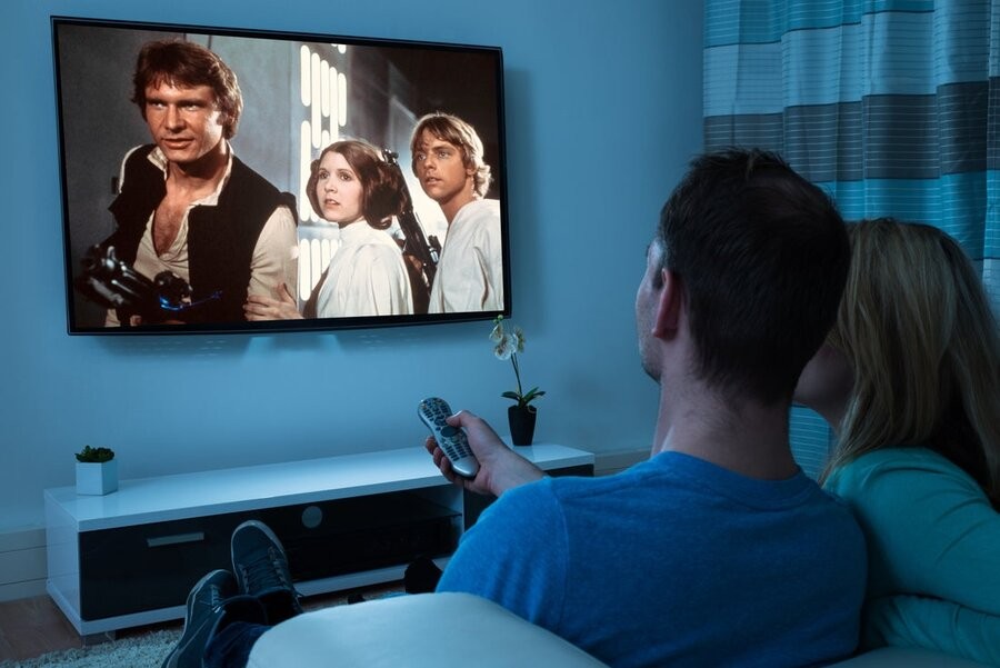 A couple watching Star Wars (1977) on an AV setup.